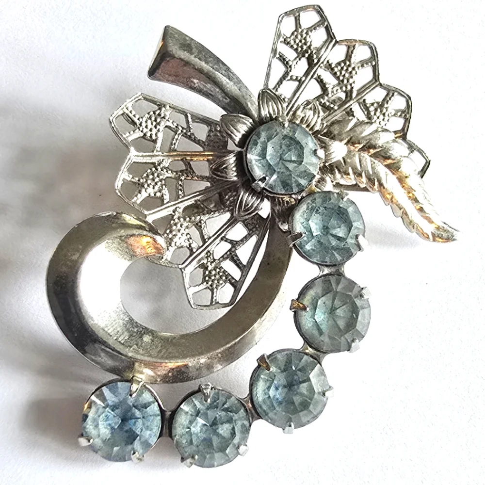 Vintage brooch pin pale blue rhinestones swirl filigree